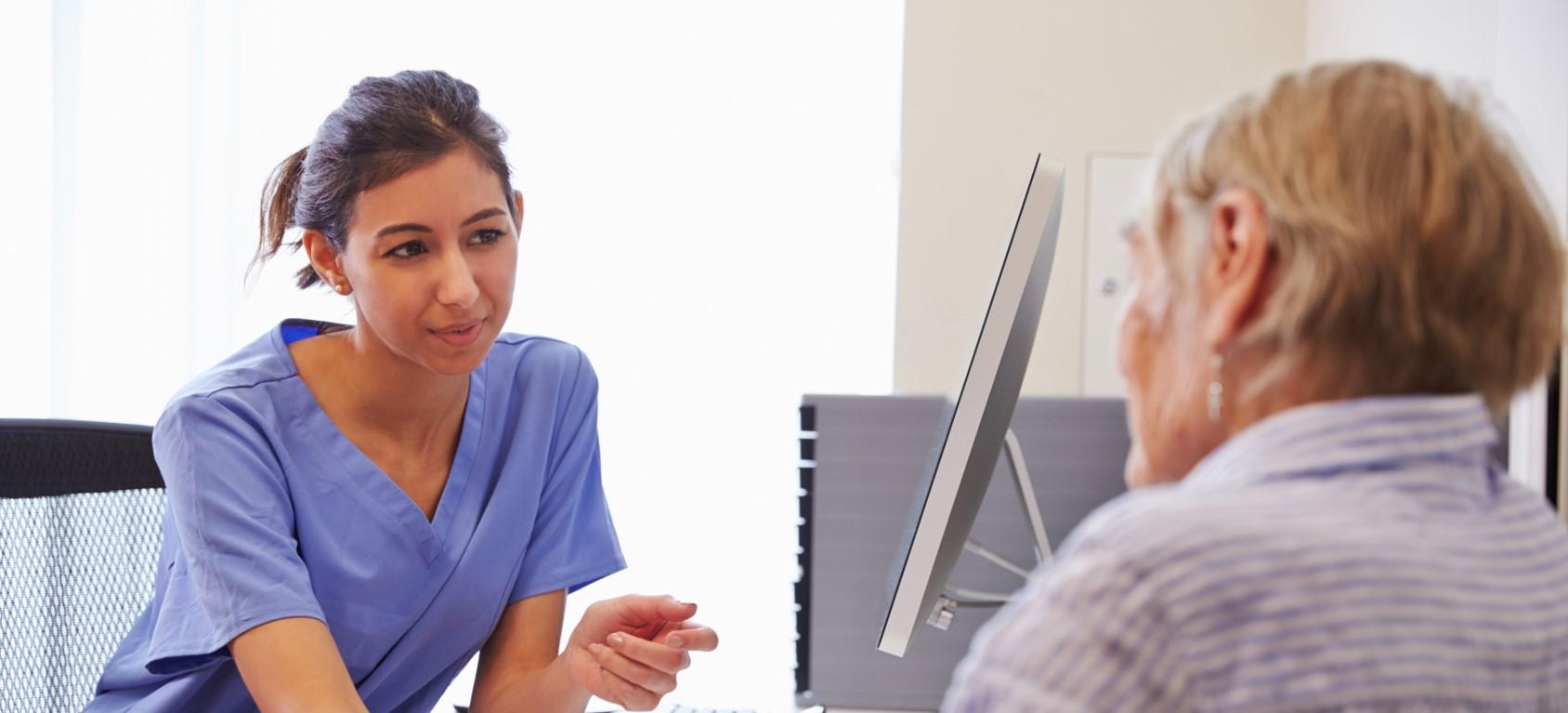 Young nurse talking to a female middle aged patient