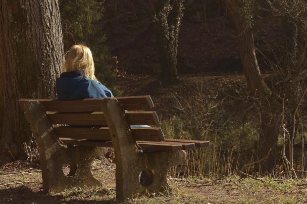 Person on bench looking away