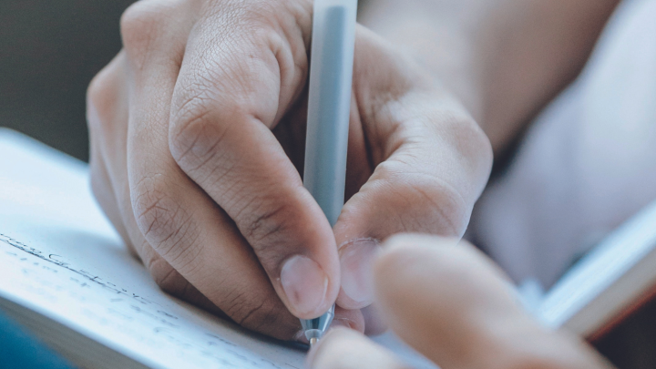 Person writing in a notebook