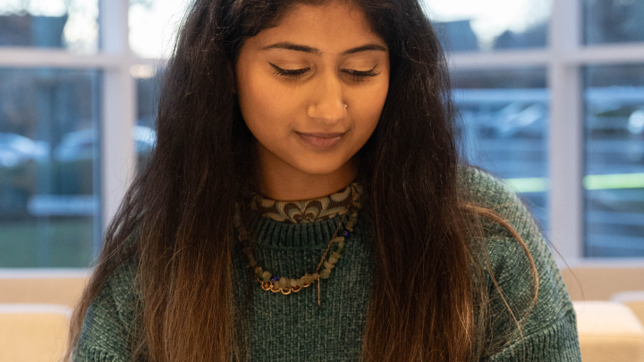 Young female sitting down looking at mobile phone