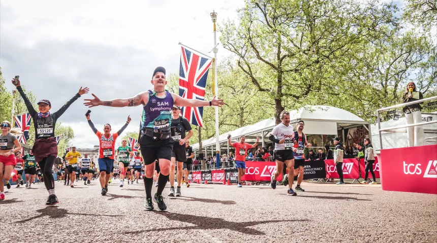 Lymphoma Action runner in running vest coming up to London marathon finishing line