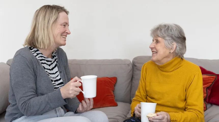 Two people talking over a hot drink