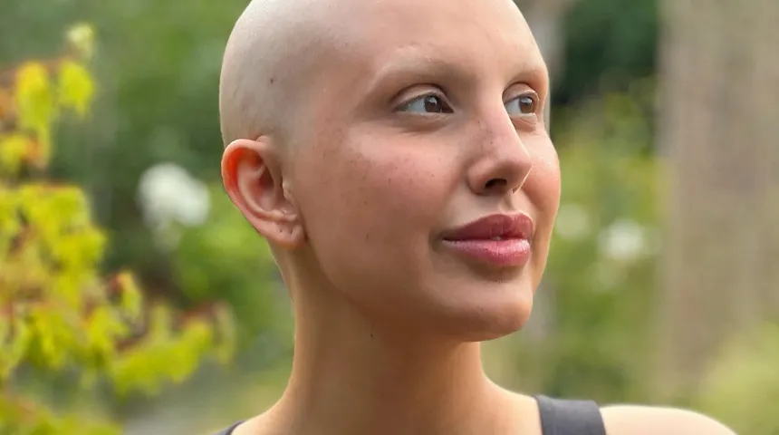 A picture of a lady outside looking into the distance