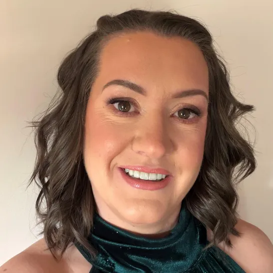 A headshot of Claire smiling to camera